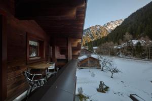 a balcony of a cabin with snow on the ground at Haus Muster - Hochmontafon in Partenen