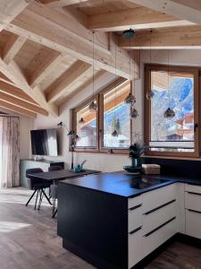 a kitchen with a black counter top in a room at Chalet Hirschegg - modernes Dorfchalet mit Panorama in Leutasch