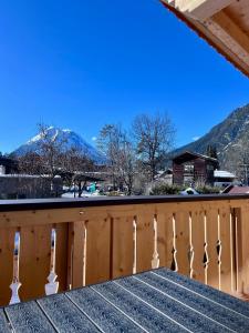 a view from the deck of a house with mountains in the background at Chalet Hirschegg - modernes Dorfchalet mit Panorama in Leutasch