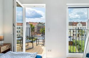 a room with a balcony with a view at Elbe Central Loft in Wittenberge