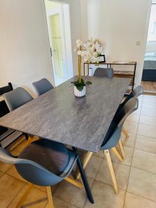 a dining room table with a vase of flowers on it at LUMINOUS SALZBURG - Kostenloser Parkplatz , Stadt Nähe in Salzburg +18 photos