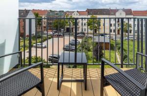 a balcony with chairs and a view of a parking lot at Elbe Central Loft in Wittenberge