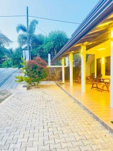 a patio of a house with tables and chairs at Yala Zafiro in Kataragama