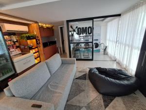 a living room with a couch and a bean bag chair at Loft Próximo à Praia de Icaraí in Niterói