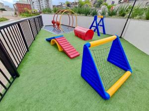 a playground with play equipment on a balcony at Loft Próximo à Praia de Icaraí in Niterói +19 photos
