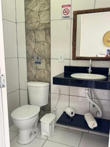 a bathroom with a toilet and a sink at Pousada Flor De Prado in Prado +20 photos