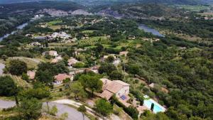 an aerial view of a house next to a river at La Rochere in Sampzon