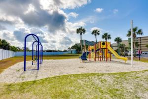 a playground with a slide in the sand at ‘Emerald Dreams’ Beach & Lakefront West PCB Condo in Panama City Beach
