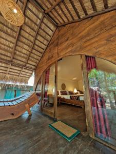a large room with a bed and a hammock in it at Gaga Bees Udawalawe in Udawalawe