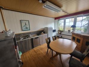a kitchen with a table and a sink and a table and chairs at Hotel Schlaun in Nordkirchen