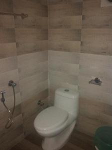 a bathroom with a toilet and a shower at Funky Art Beach House in Alleppey +37 photos