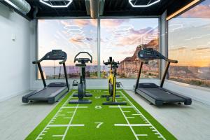 a gym with three tread machines in front of a large window at Amadores View - Adults only in Mogán