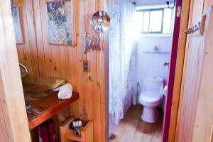 a small bathroom with a toilet and a sink at Horizonte Infinito in Tunquén +96 photos