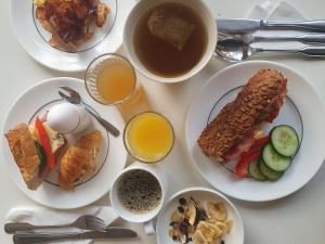 a table with plates of food and a cup of coffee at Hotel Bishops Arms Strängnäs in Strängnäs