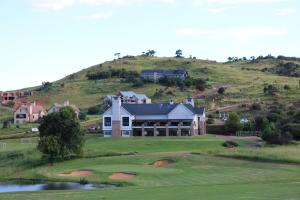 a house on top of a hill with a golf green at Highland Gate Golf & Trout Estate, House 925 in Dullstroom