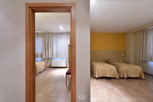 Letto o letti in una camera di Tatì Hotel