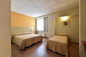 Letto o letti in una camera di Tatì Hotel