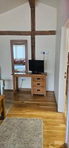 a room with a desk with a television on it at The Chalet in Oxford