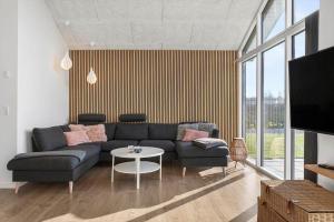 a living room with a couch and a table at SB128-Krusa-Hyldemose-23 in Skovbyballe