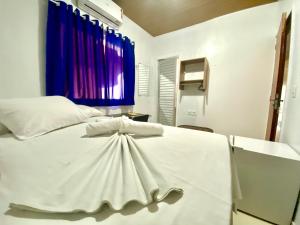 a white bed in a room with a window at Hotel Xingu in Altamira +21 photos