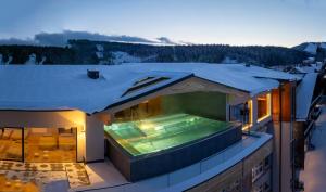 a house with a swimming pool on the roof at Hotel Pehab - Rooftop-Spa in Ramsau am Dachstein