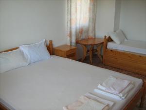 a bedroom with a bed and a chair and a table at Villa Victoria in Sinemorets