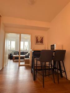 a living room with a table and chairs and a couch at Westwind 2 in Steinfeld +6 photos