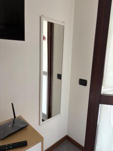 a mirror on a wall next to a desk at Casa Menotti in Carate Brianza +4 photos