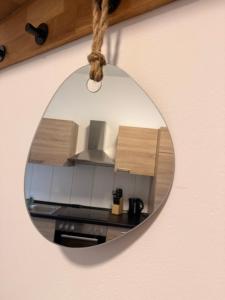 a mirror hanging on a wall with a kitchen at Westwind 2 in Steinfeld