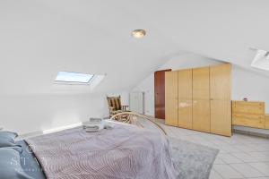 a living room with a bed and a cabinet at Appartement à Schifflange in Schifflange