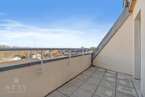 a balcony with a view of a city at Appartement à Schifflange in Schifflange