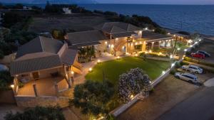 an aerial view of a house with a lawn at Iliovasilema Hotel in Mytikas
