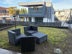 two chairs and a table in front of a house at Casa Menotti in Carate Brianza