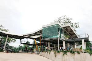 a large glass building with people sitting in it at Amaya View in Balulang