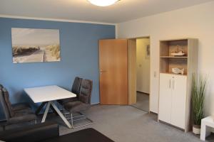 an office with a desk and chairs and a table at Landhaus Behrenwalde in Weitenhagen