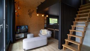 a living room with a staircase and a living room with a ladder at Forest Cube in Oignies