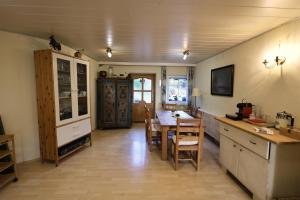 a kitchen with a table and a dining room at Bio-Bauernhof, Pferdehof Gräser in Viehberg