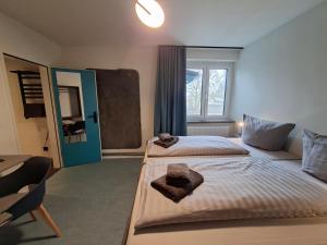 a bedroom with two beds and a window at KulturHaus Locktow in Locktow