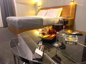 a table with a bowl of fruit and a glass of wine at Rosse Hotel in Esenyurt +53 photos