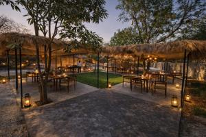 an outdoor dining area with tables and lights at Badi Meadows By Wilkisto Near Fatehsagar Lake in Udaipur