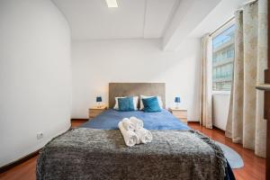 a bedroom with a bed with two towels on it at Funchal Paradise in Funchal