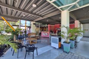 a patio with tables and chairs and a restaurant at Amaya View in Balulang