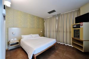 Letto o letti in una camera di Tatì Hotel