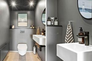 a bathroom with two sinks and a toilet at LK2209-Lokken-Soltoften-50 in Nørre Lyngby +19 photos