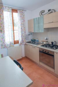 a kitchen with a sink and a stove top oven at Casa da Luna in Parma