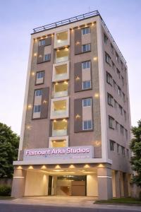 a building with a sign on the front of it at Hotel Flamount Arka Studios in Hyderabad