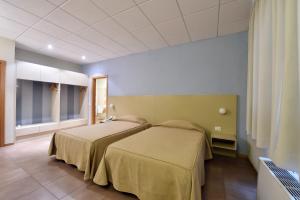 Letto o letti in una camera di Tatì Hotel