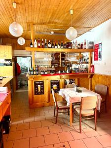 a restaurant with a table and chairs in a kitchen at Penzion Pstruh Stožec in Stožec