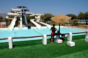 a person sitting at a table in front of a water park at Casas Adosadas Lambda in Almuñécar