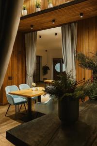 a dining room with a wooden table and chairs at No107 Predeal in Predeal